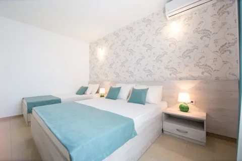 Bright bedroom with a double bed and an extra single bed. - image 2