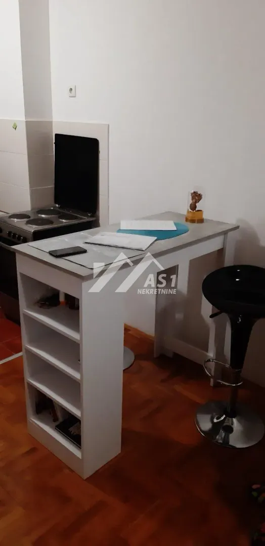 Small kitchen with a dining bar and a bar stool.
