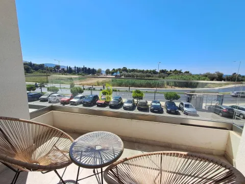 Furnished balcony with seating set and view of the parking lot and surroundings. - image 12