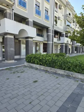 Exterior of a residential building with a paved path and greenery. - image 2