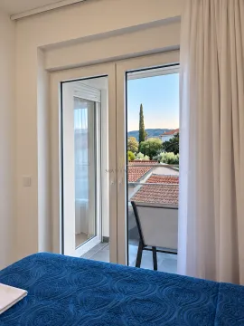 View from the bedroom through the balcony doors to the surroundings. - image 8