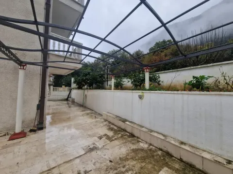 Tiled yard with a metal canopy structure next to the house. - image 8