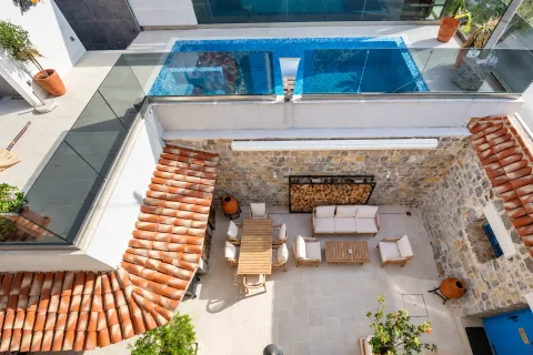 Terrace with seating furniture and a swimming pool on the upper level. - image 16