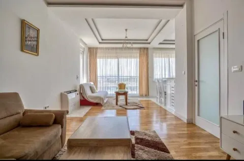 Spacious living room with a sofa, dining area, and access to the terrace. - image 8