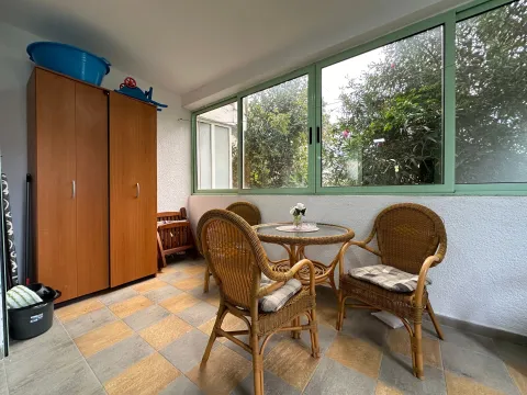 Enclosed terrace with dining furniture and a wardrobe. - image 12