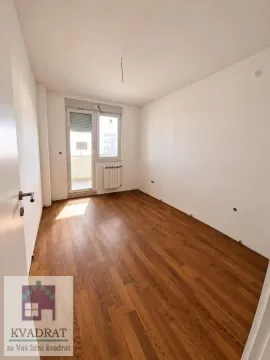 Empty room with wooden flooring and access to the balcony. - image 5
