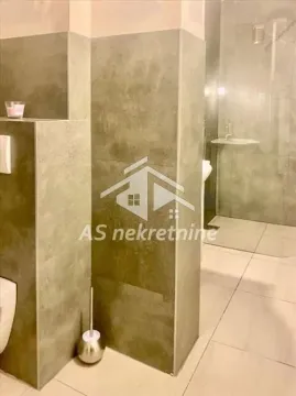 View of a modern bathroom equipped with grey ceramic tiles. - image 8