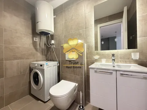 Modernly equipped bathroom with a shower, washing machine, and built-in units. - image 11