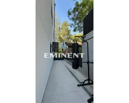 Side yard of the building with workout equipment installed. - image 18