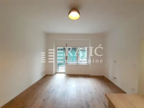 Empty living room with wooden flooring and access to a terrace. - image 3