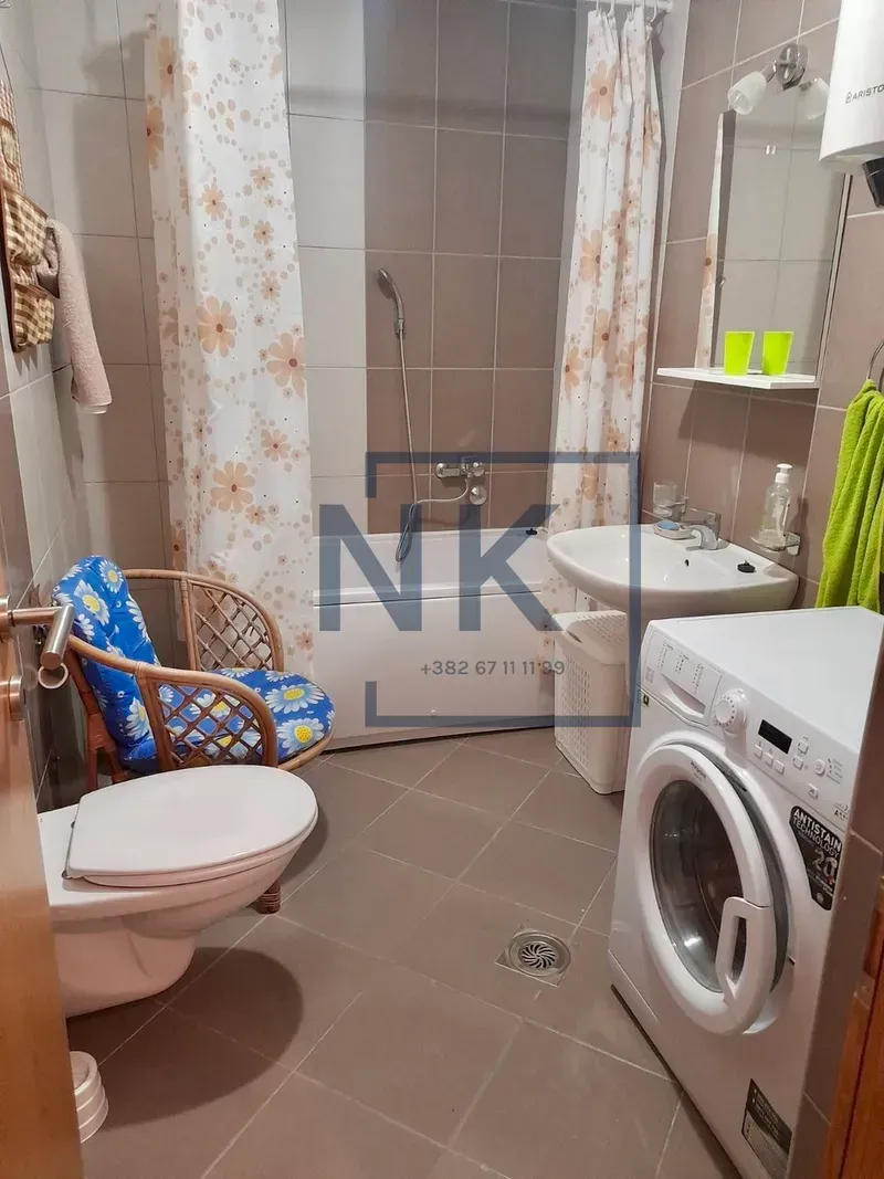 Bathroom equipped with sanitary ware, bathtub, and washing machine.