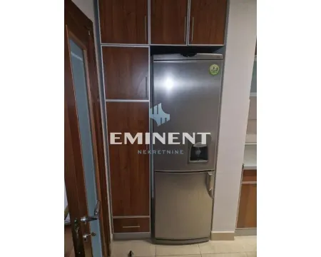 Kitchen with refrigerator and built-in kitchen cabinets. - image 7