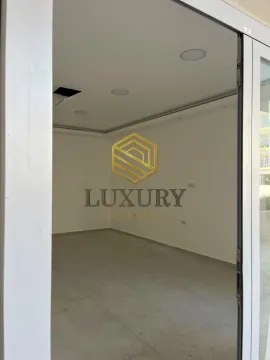 Empty unfurnished room with white walls and floor tiles. - image 2