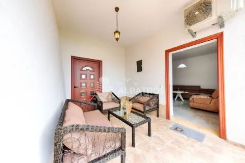 Covered terrace furnished with a seating set facing the entrance door. - image 2
