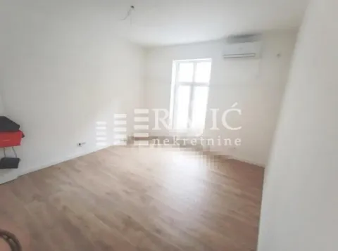 Empty room with laminate flooring and an air conditioner. - image 5