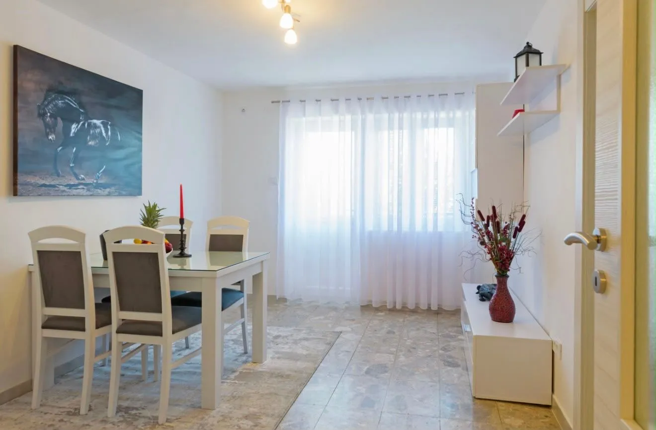 Bright living room with a dining table and chairs.