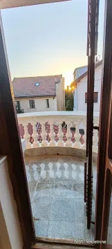 View from the balcony overlooking surrounding buildings and the neighborhood. - image 7