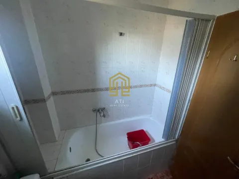 Bathroom with a bathtub and ceramic tiles. - image 8