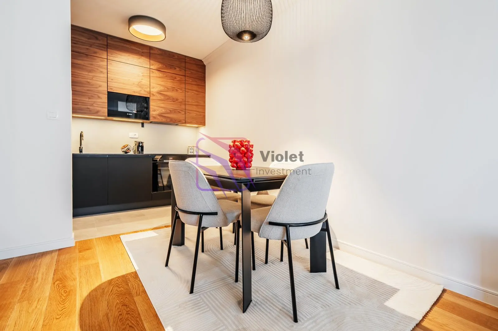 Modern kitchen with a dining area and wooden cabinets.
