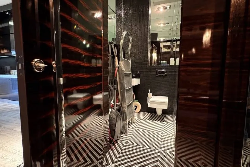 View of a modernly designed bathroom with black and white tiles.