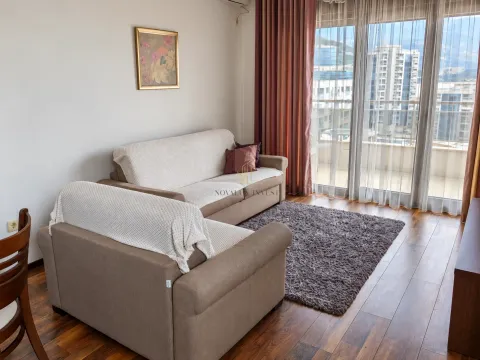 Living room with a sofa set and large balcony doors. - image 2