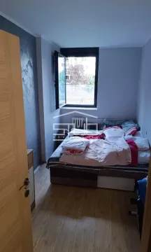 Smaller bedroom with a bed and a window overlooking the outside. - image 7