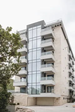 Exterior view of a modern residential building with balconies and large glass surfaces. - image 15