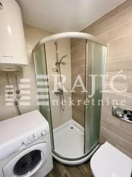 Small bathroom with a shower cabin, washbasin and washing machine. - image 10