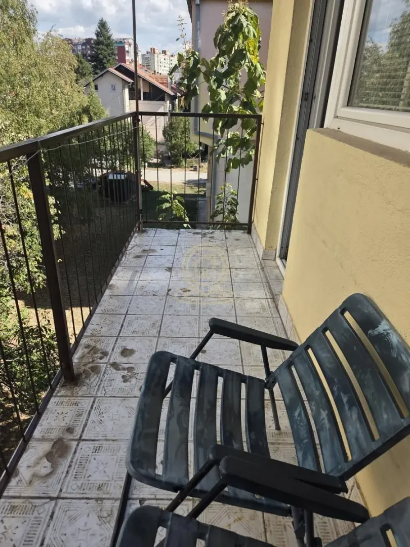 Smaller balcony with a metal railing and a neighborhood view.