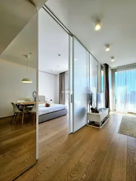 Modern bedroom with a double bed and a glass partition wall. - image 8