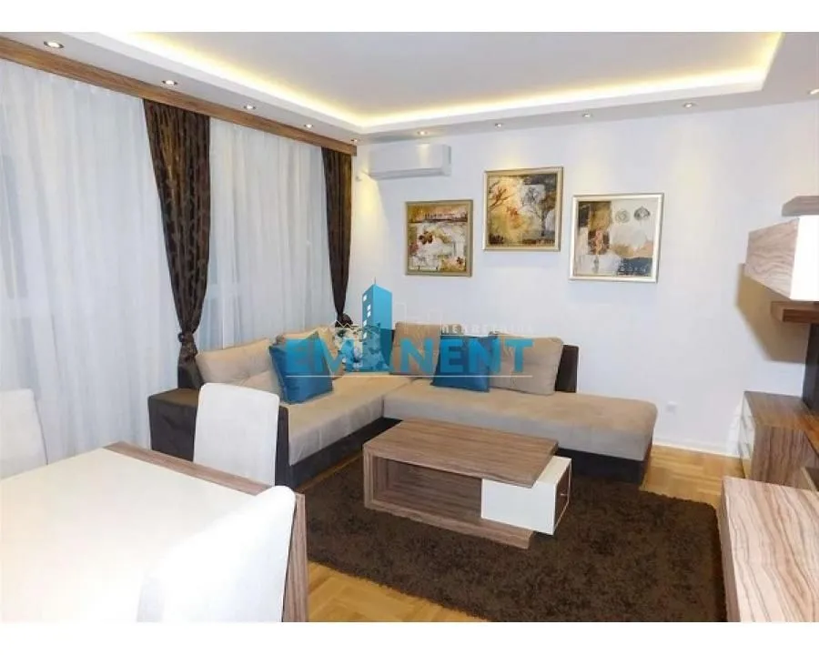 Comfortable living room with a sectional sofa, coffee table, and dining table.