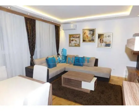 Comfortable living room with a sectional sofa, coffee table, and dining table. - image 12
