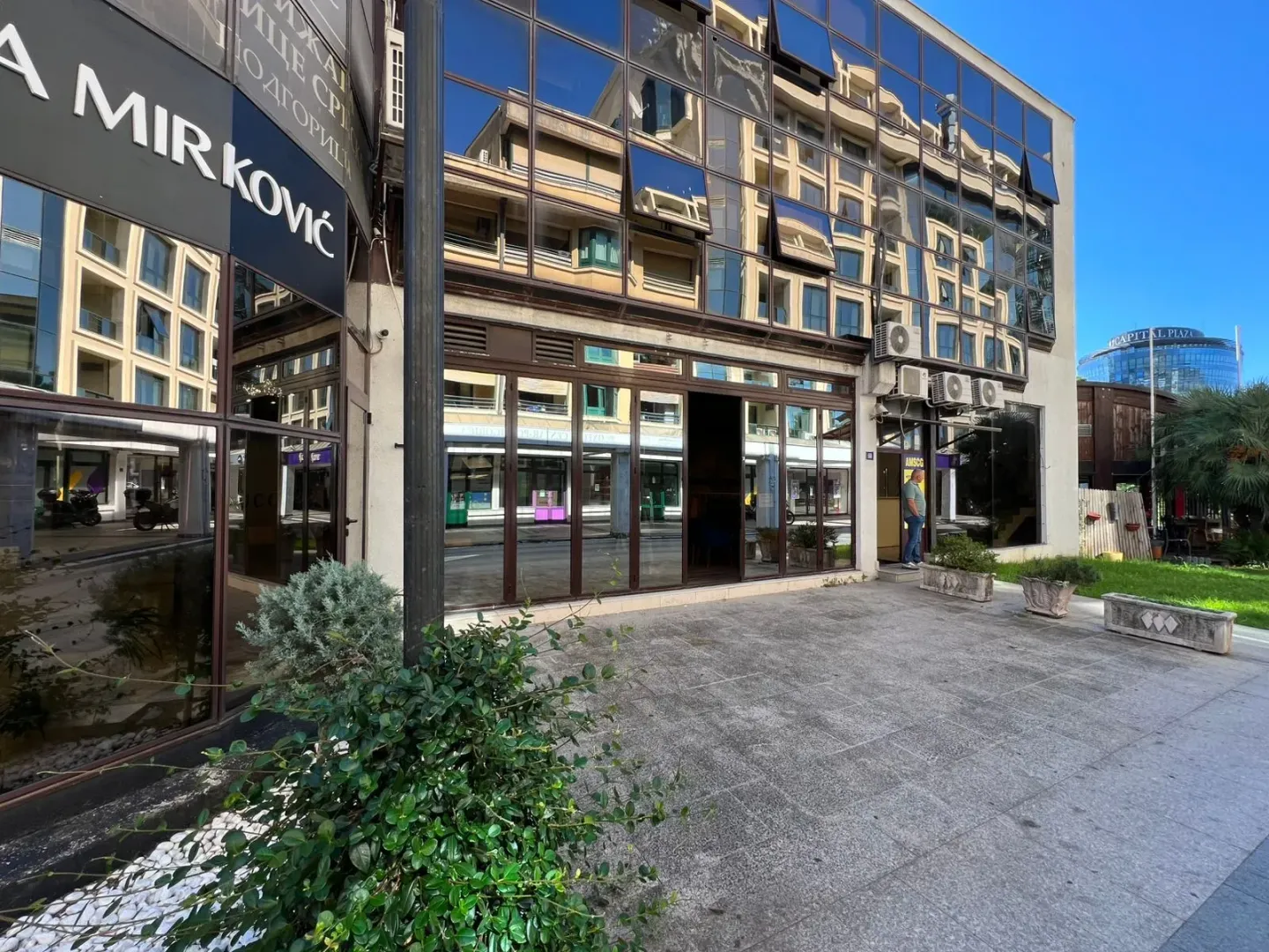 Exterior view of the commercial space with large glass surfaces and an entrance.