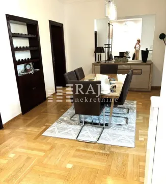 Living room with dining area and parquet flooring. - image 4
