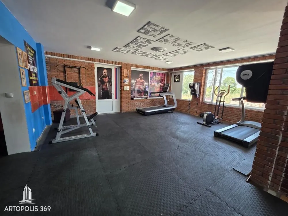 Interior of the gym with exercise equipment and rubber flooring.