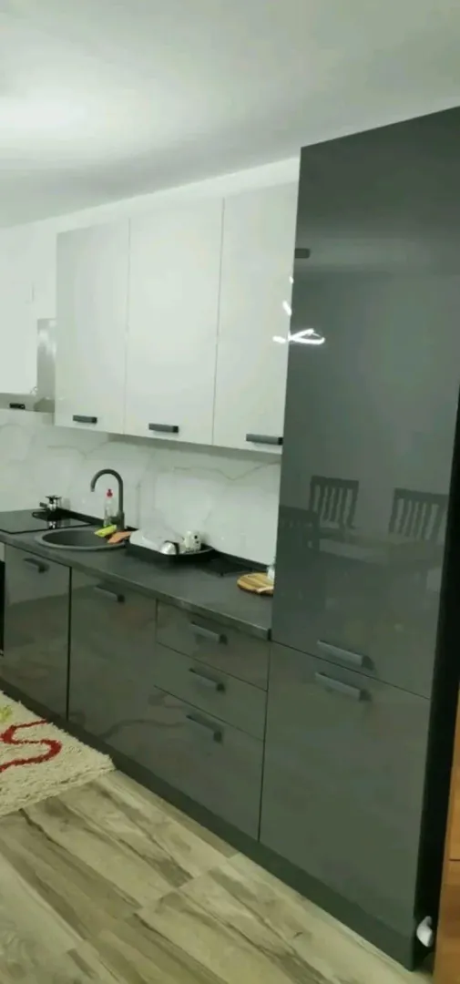 Modern kitchen with grey and white cabinets.