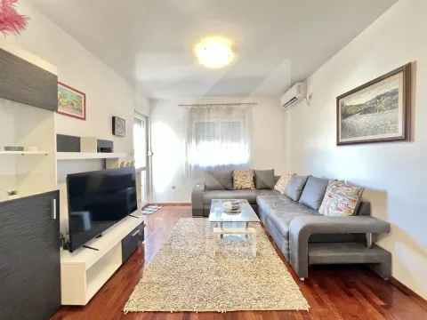 Living room with a sectional sofa, TV, and dining area. - image 2