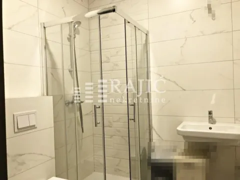 Modernly equipped bathroom with a shower cabin and a sink. - image 12