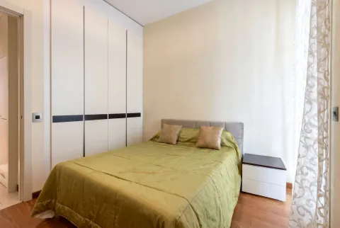 Furnished bedroom with a double bed, wardrobe, and nightstand. - image 9