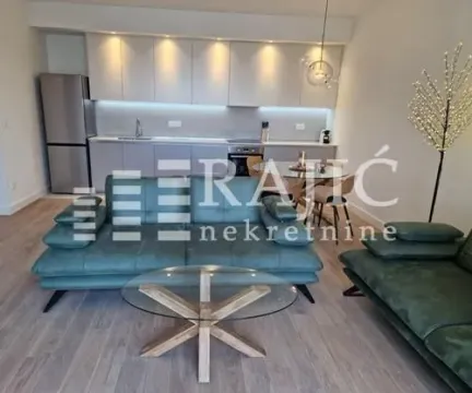 Living room with a sofa set and a dining area integrated with the kitchen. - image 5