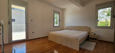 Bright bedroom with a double bed, wooden floor and balcony access. - image 9