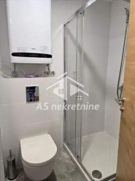 Modernly equipped bathroom with a walk-in shower and water heater. - image 14
