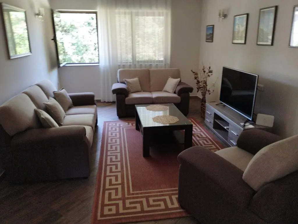 Living room with a sofa set, coffee table, and TV.