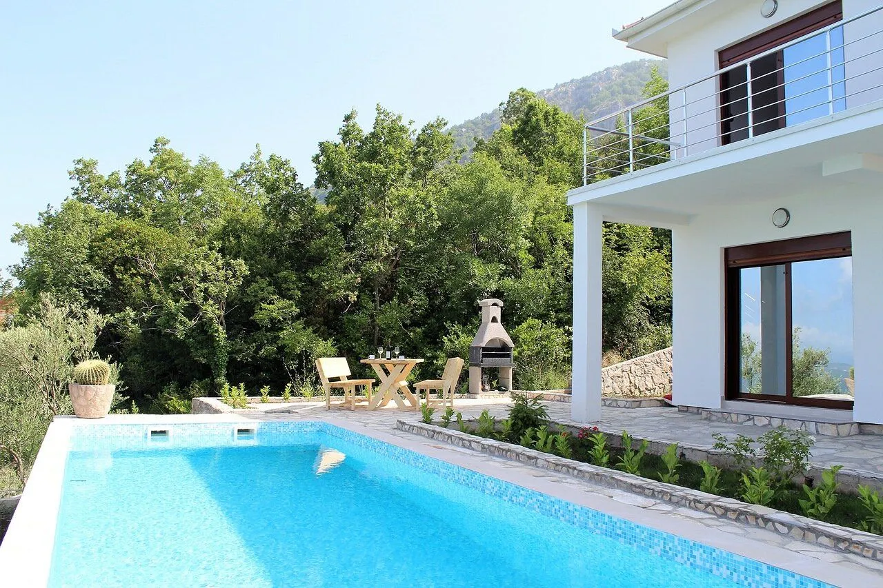 Exterior of the house with a swimming pool and terrace.