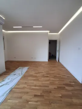Empty room with wooden parquet flooring and white walls. - image 10