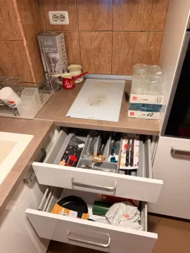Kitchen detail with open drawers and kitchen utensils. - image 7
