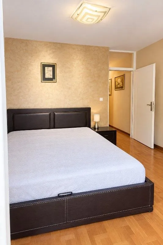 Furnished bedroom with a double bed and a nightstand.