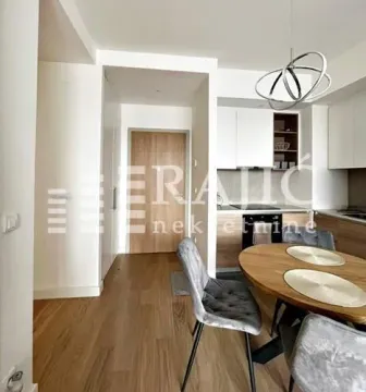 Living room with dining area and kitchen in the background. - image 5