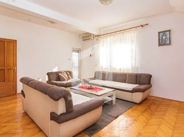 Living room with a seating set and wooden flooring.