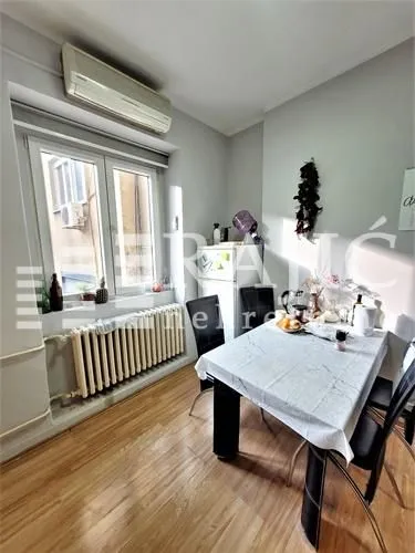 Smaller kitchen with a dining table and window.